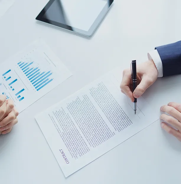 Lawyer assisting a client with signing a legal contract during a consultation in Stockholm.