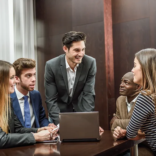 A diverse team of legal professionals collaborating during a meeting in a modern law office.