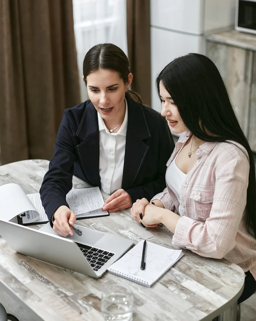Two professionals reviewing a confidential agreement together at an office table