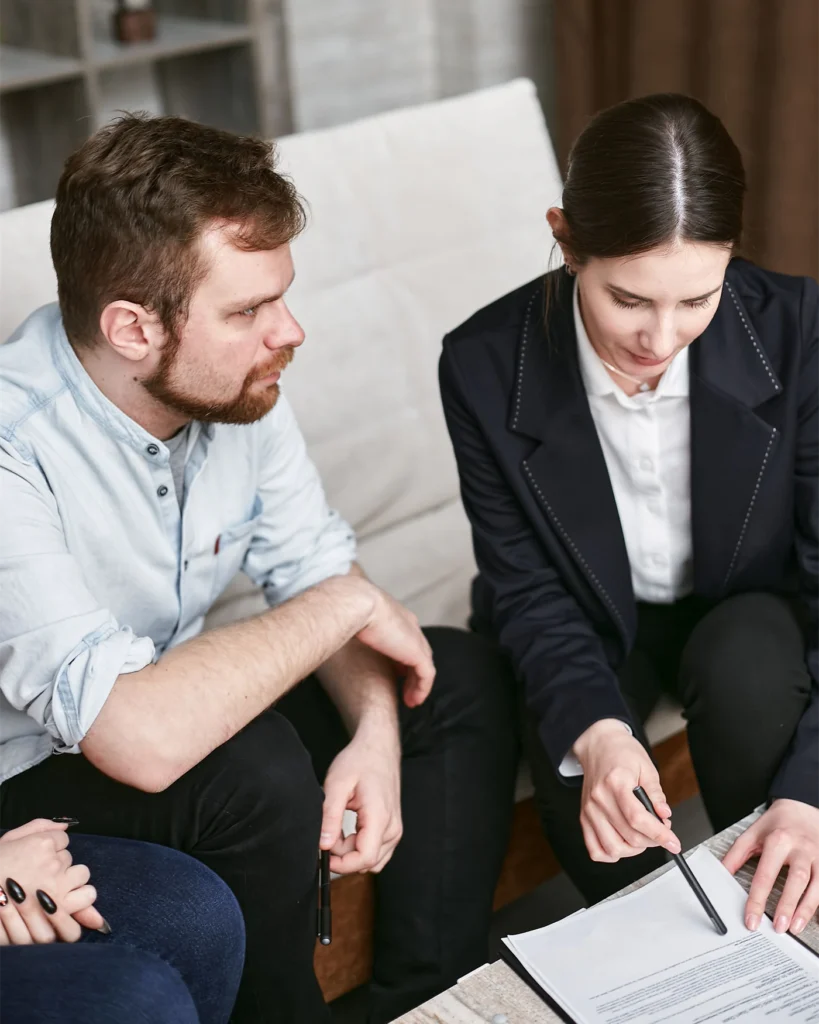 Two colleagues seated together reviewing documents in a calm discussion