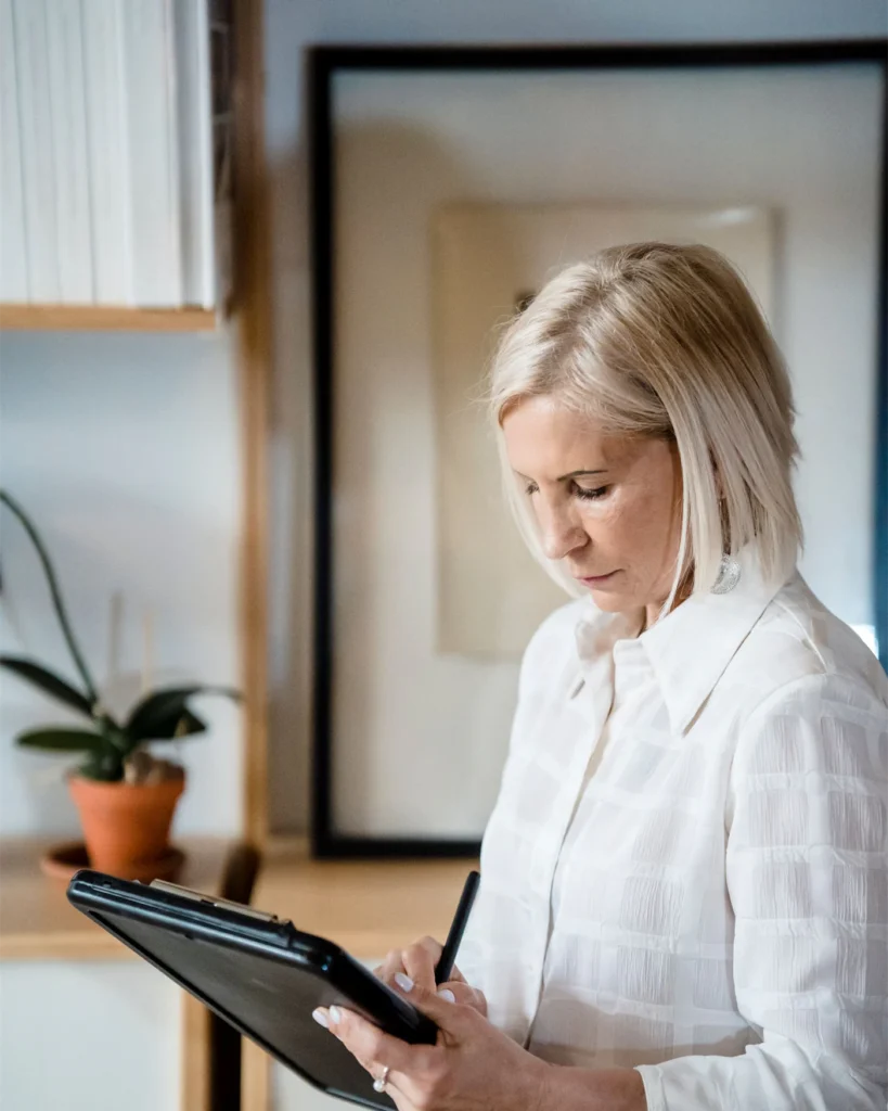 An adviser making notes on a case in a bright office