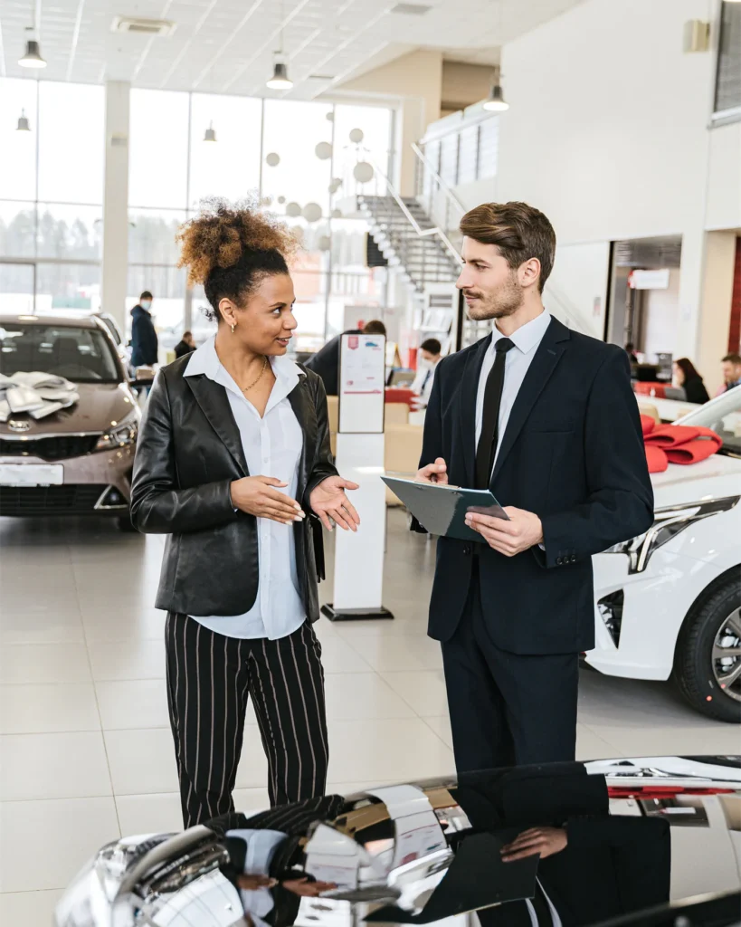 A customer and a dealership representative going through details on a tablet
