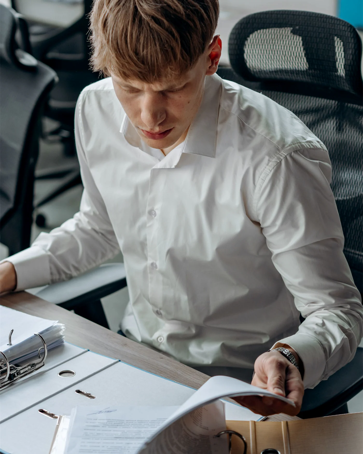 A lawyer reviewing a case file at an office desk