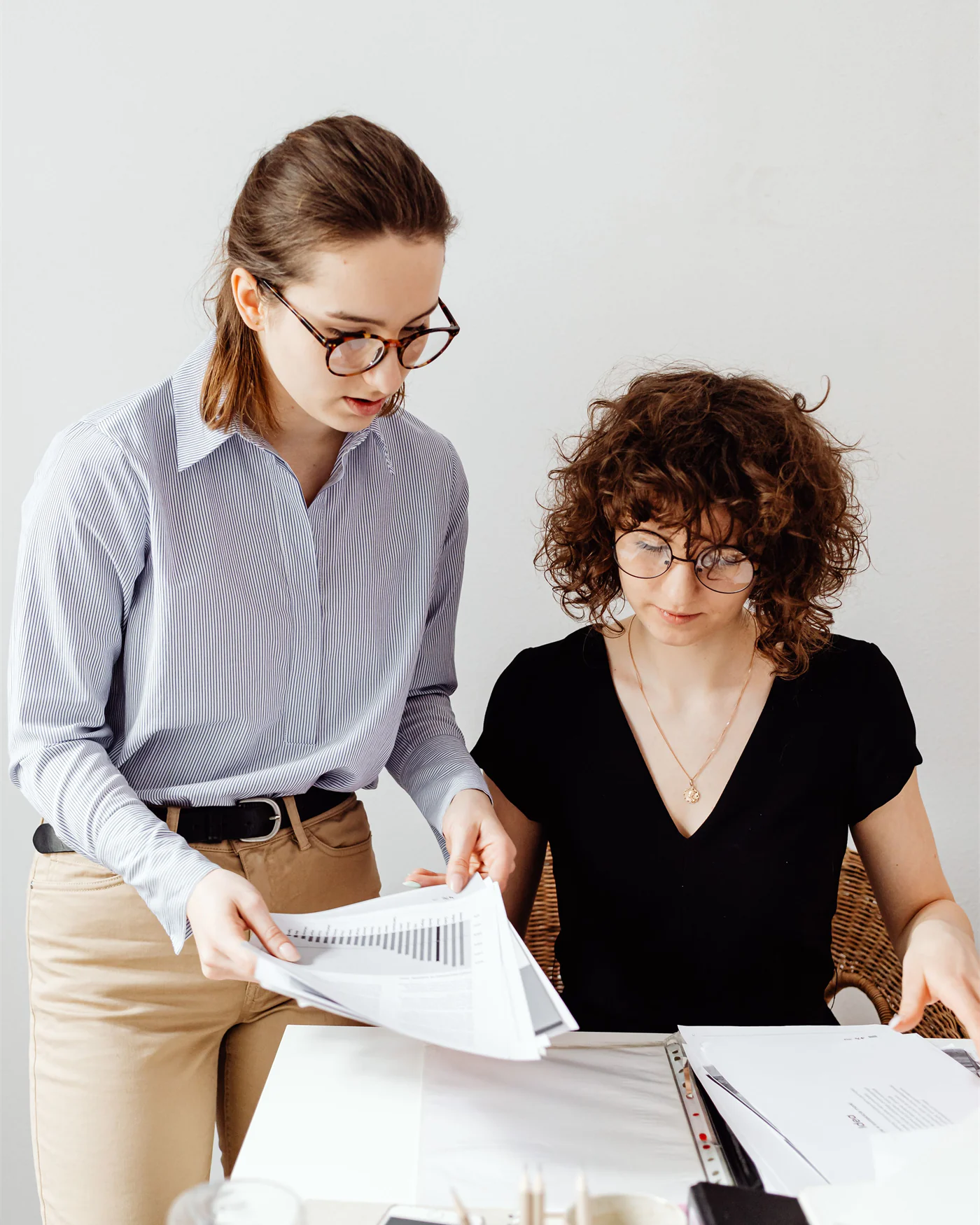 Adviser going through documents with a client at a desk
