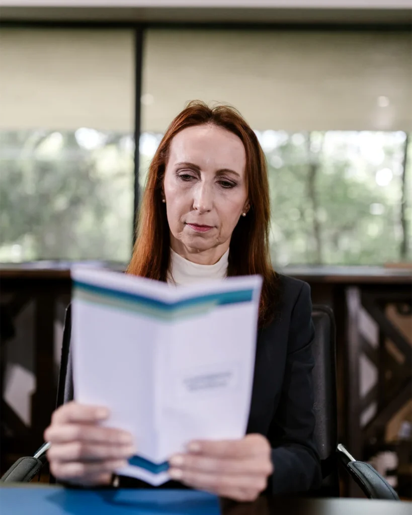 Adviser reading through a document at a meeting table