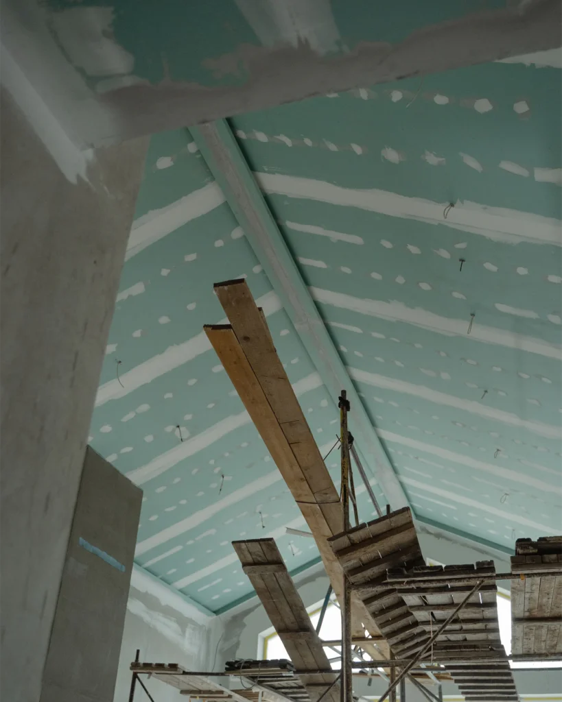Scaffolding and ceiling boards inside a building under construction