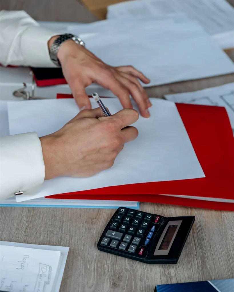 Working through a claim with a calculator and case notes