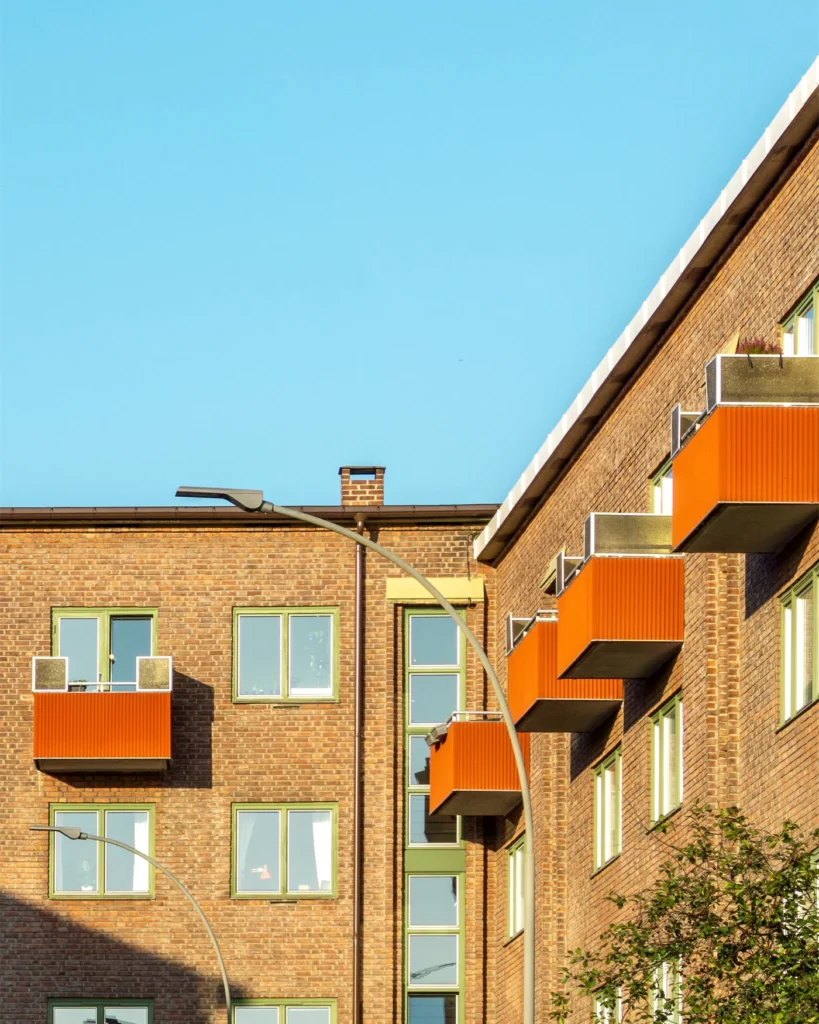 Brick apartment building with balconies on a clear day