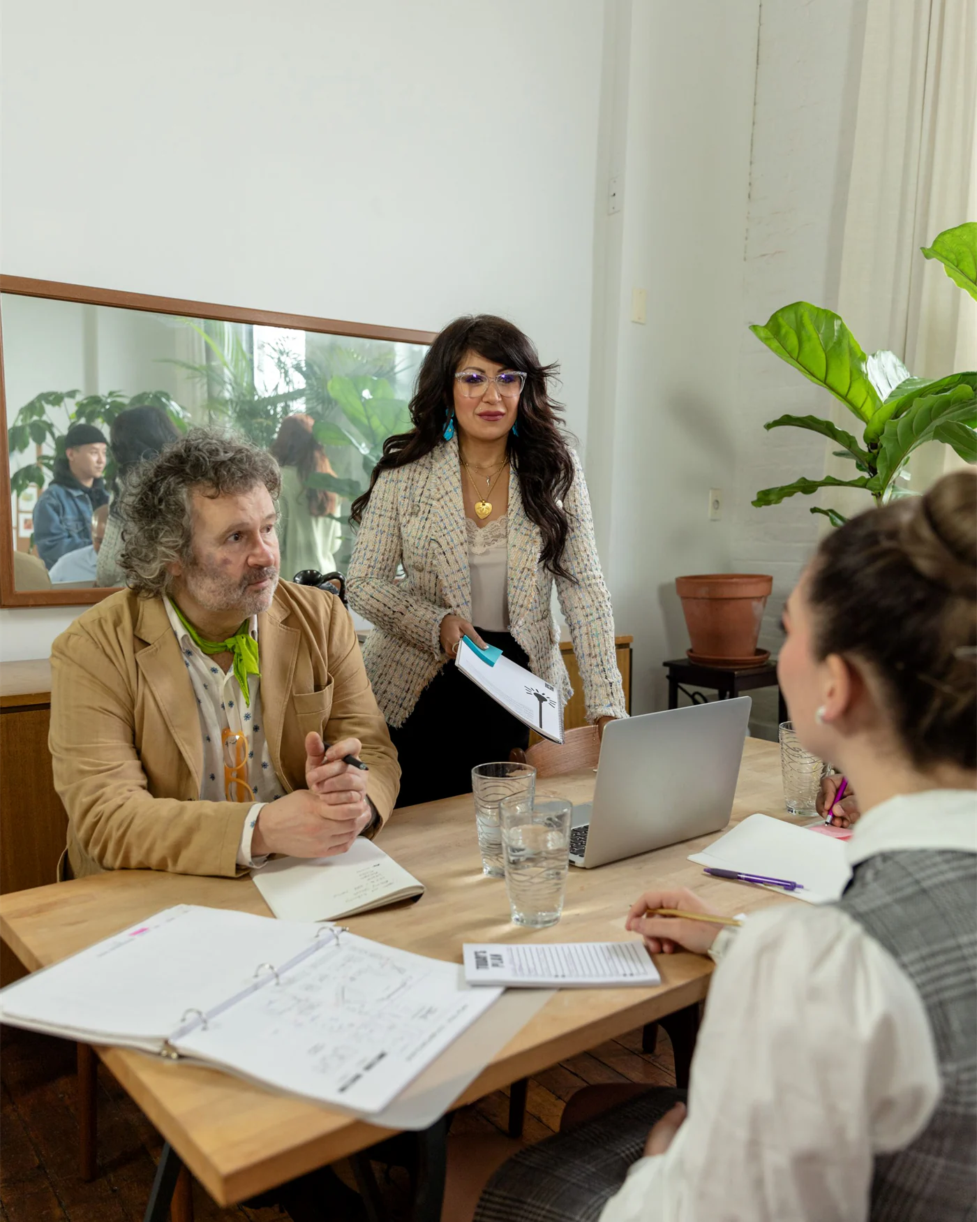 Colleagues seated around a table in a calm working discussion