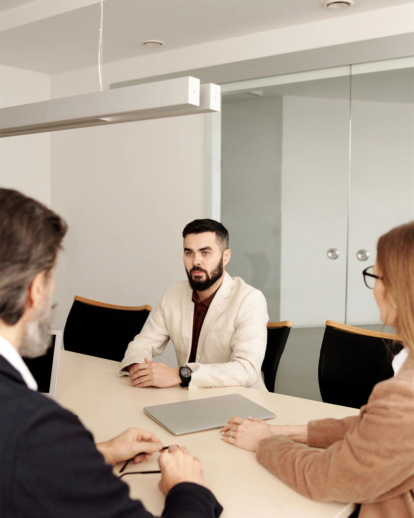 Colleagues meeting around a table in a bright minimal office