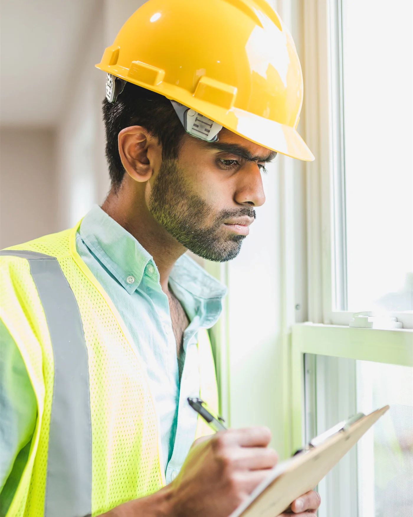 Loss adjuster recording details on a clipboard during a site assessment