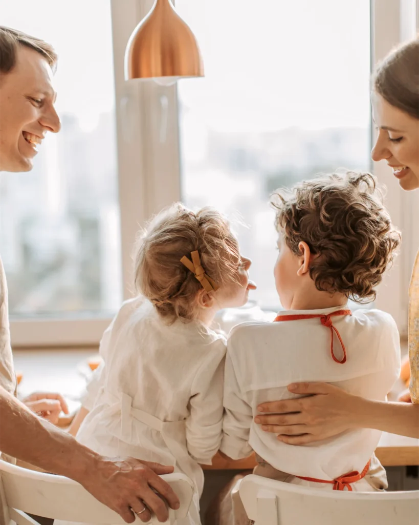 A family together by a sunlit window at home