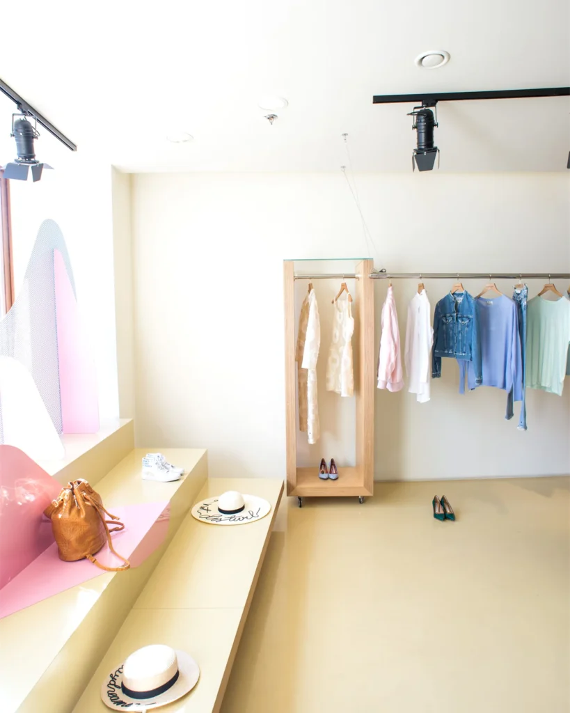 A bright boutique interior with a clothing rail