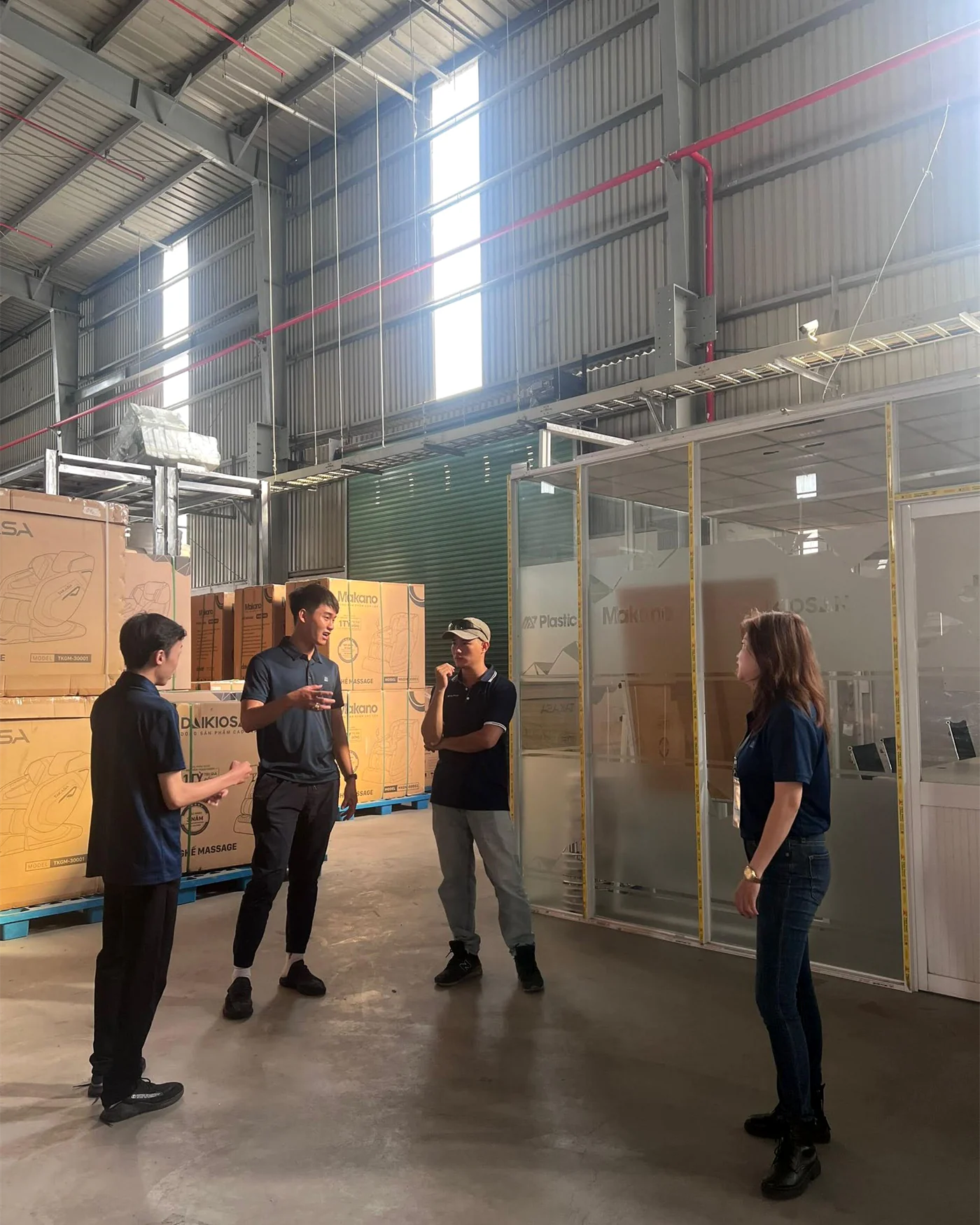 Colleagues in discussion inside a large commercial warehouse