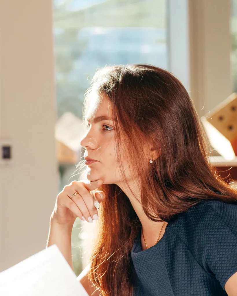 A woman considering her options with paperwork in front of her