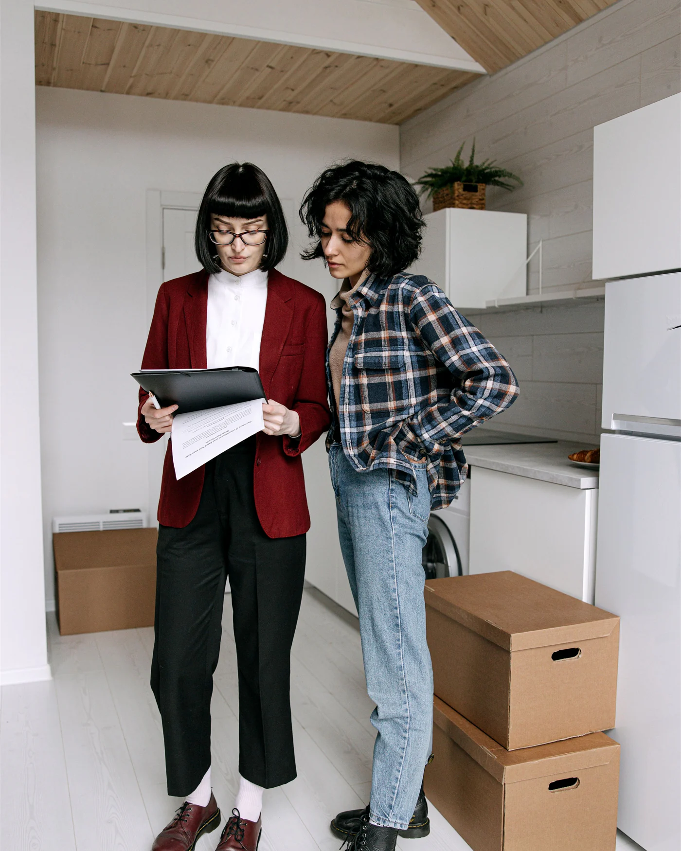 Two tenants going through a lease document in an apartment