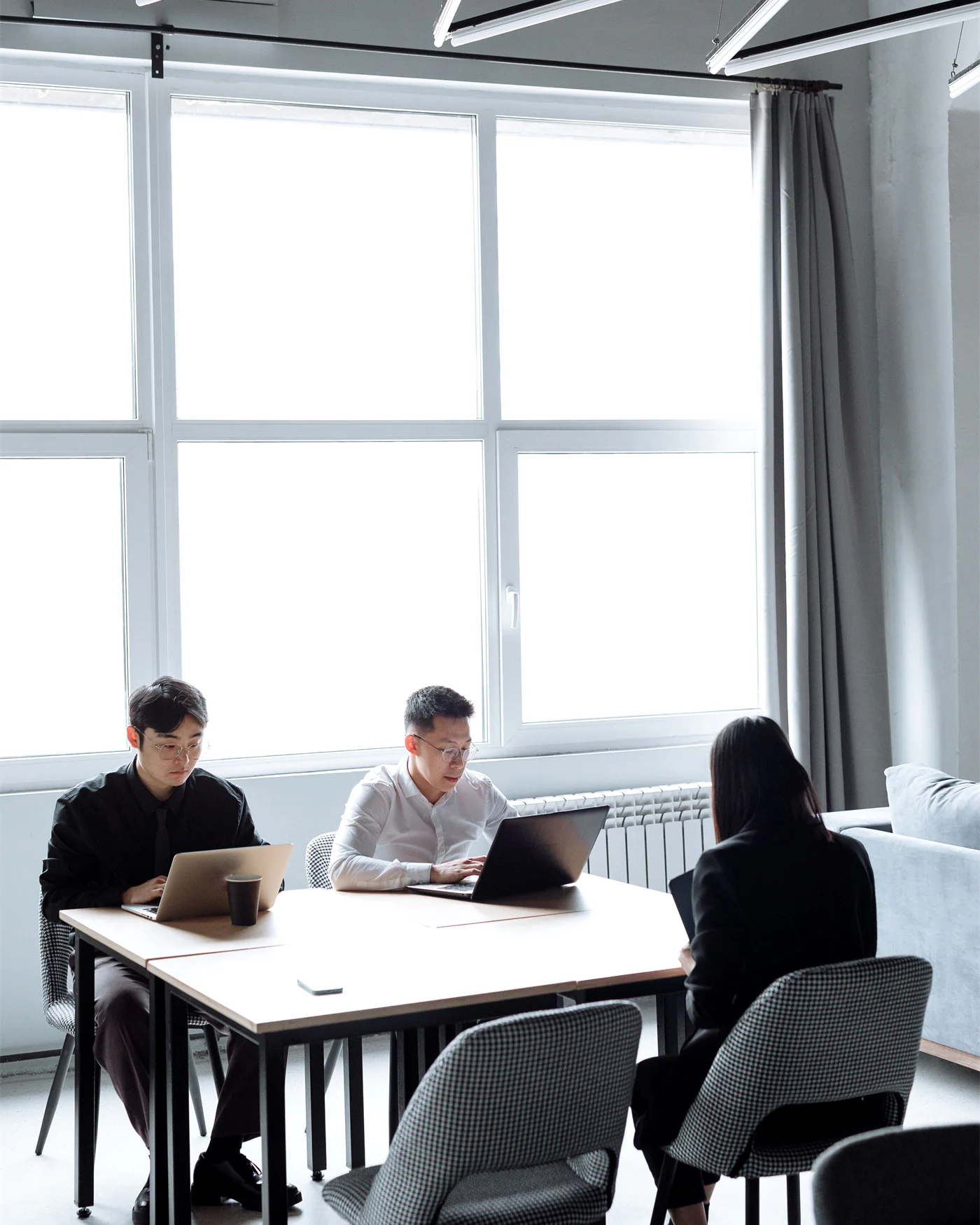 Colleagues working at a table in a bright office