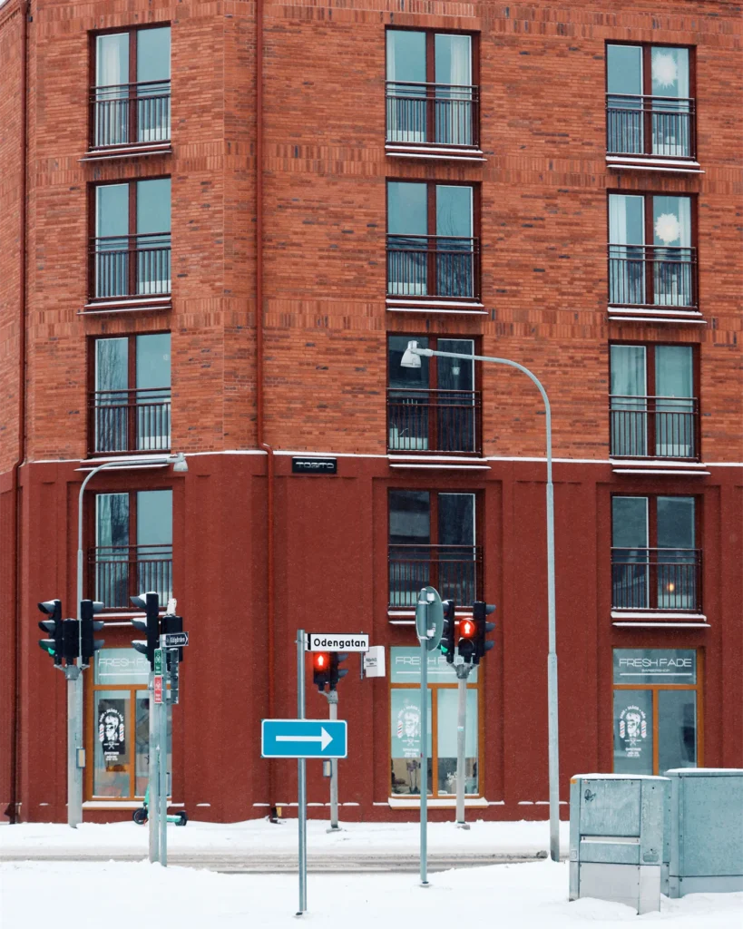 Red brick apartment building on a Stockholm street in winter