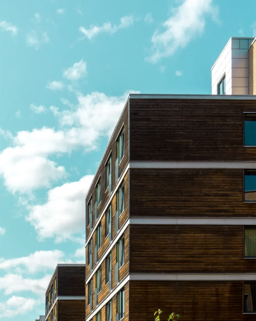 Modern apartment building with a timber facade against the sky
