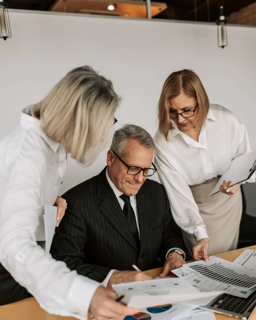 Adviser and managers working through a case at a meeting table