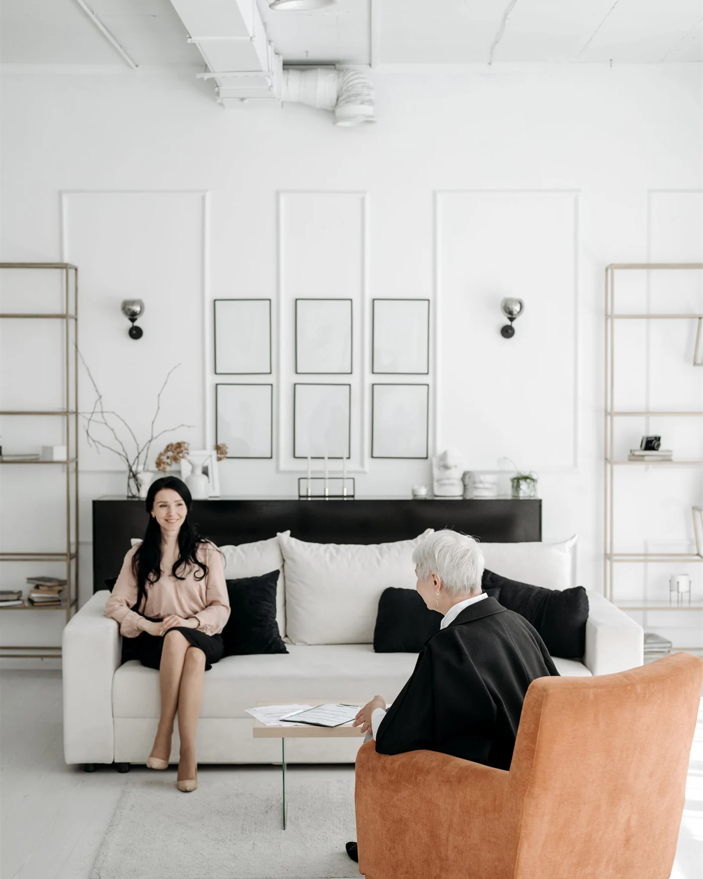 An adviser and a client discussing an agreement in a bright, minimal room