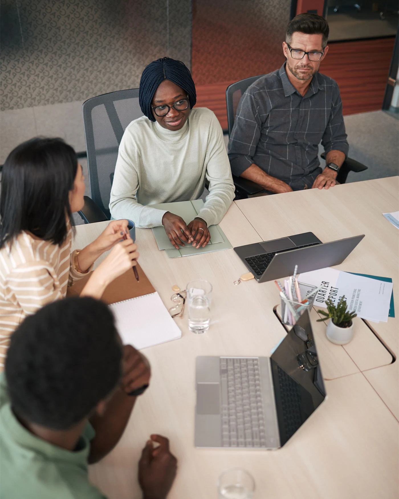 Colleagues seated around a meeting table discussing workplace matters