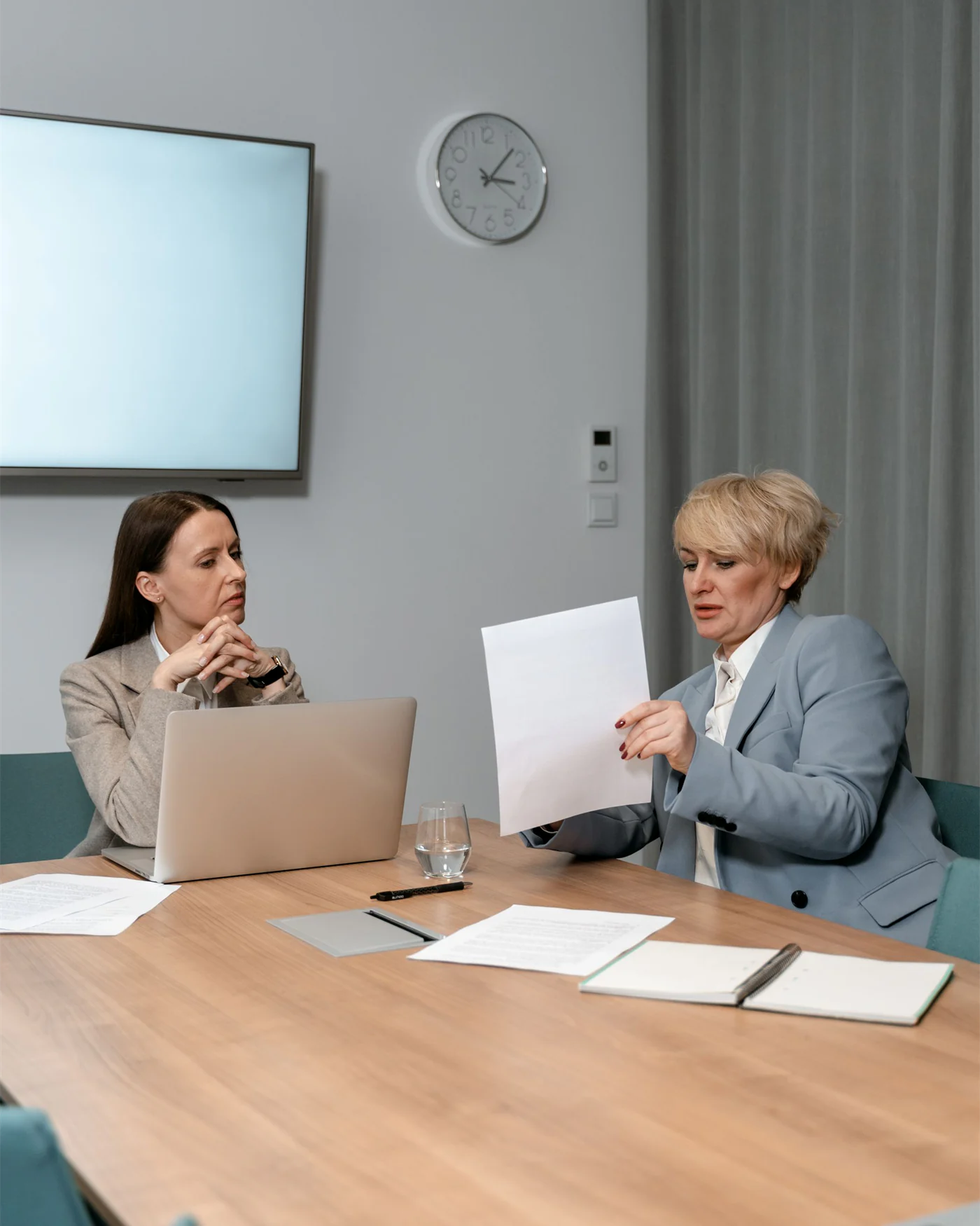 Colleagues seated around a meeting table discussing workplace matters