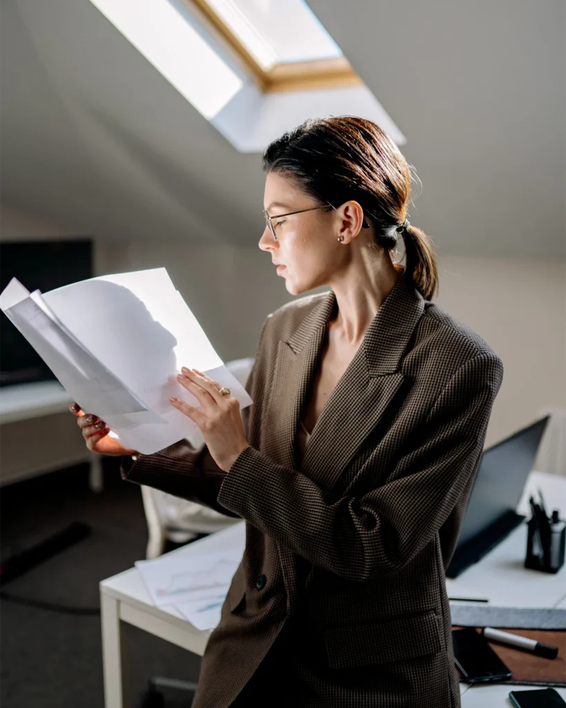 A business owner reading through paperwork in an office