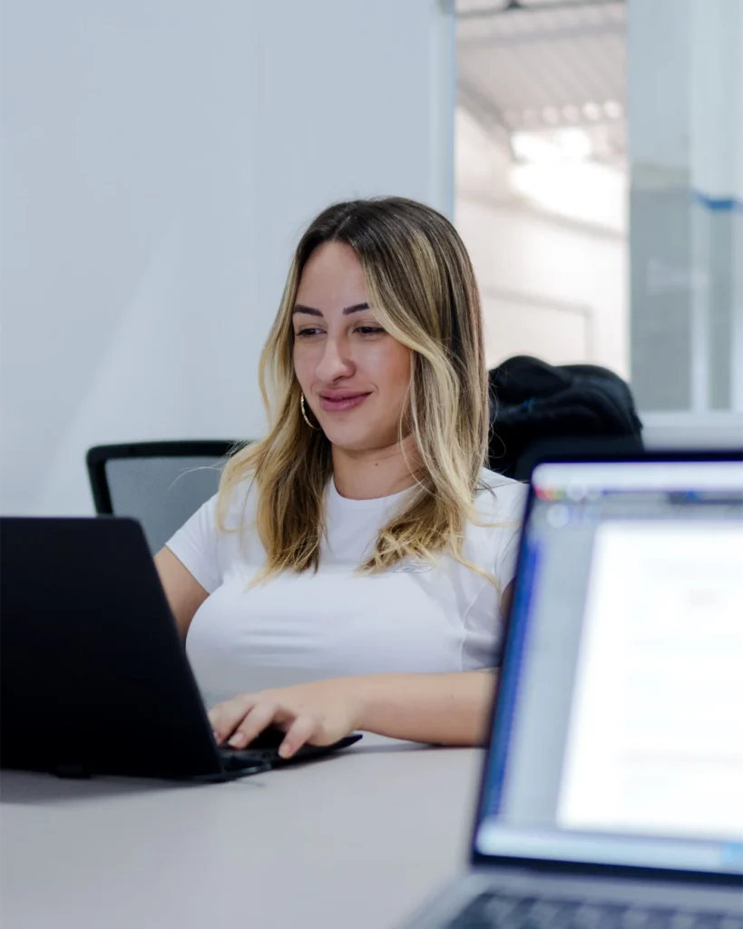 Employee working at a laptop in a bright modern office