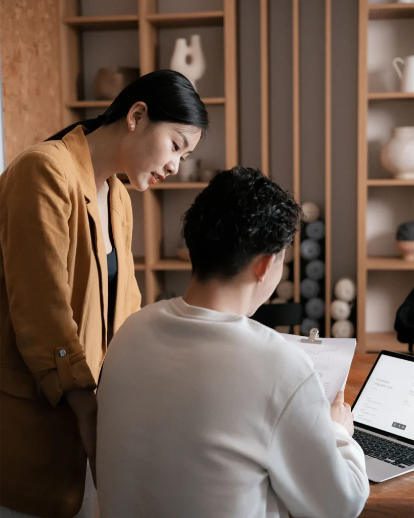 Adviser going through documents with a client at a desk