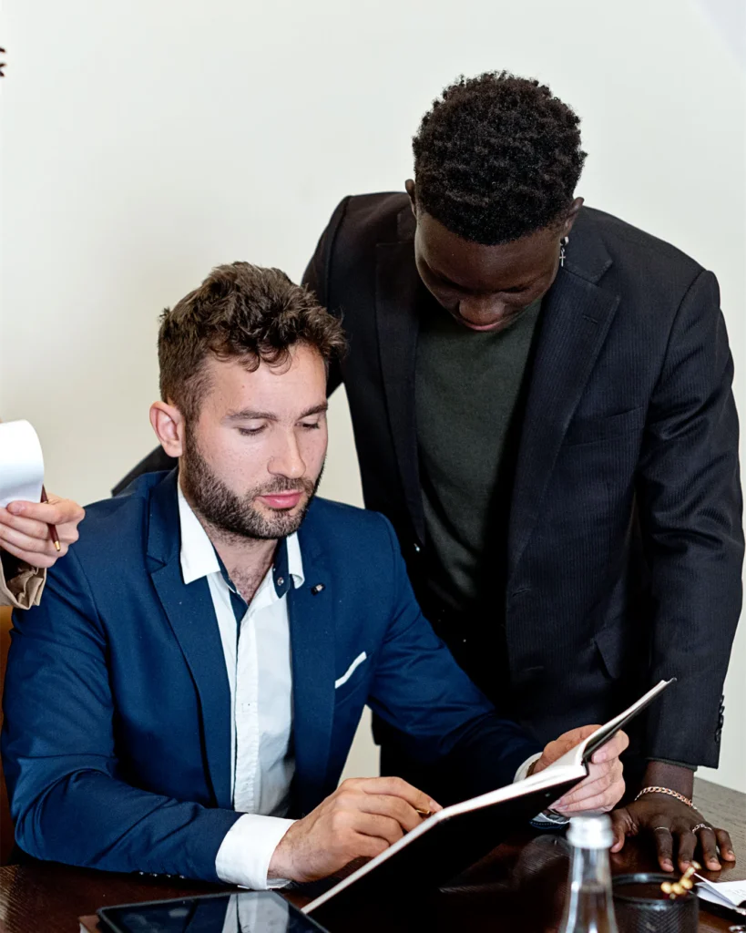 Adviser going through a document with an executive at a table