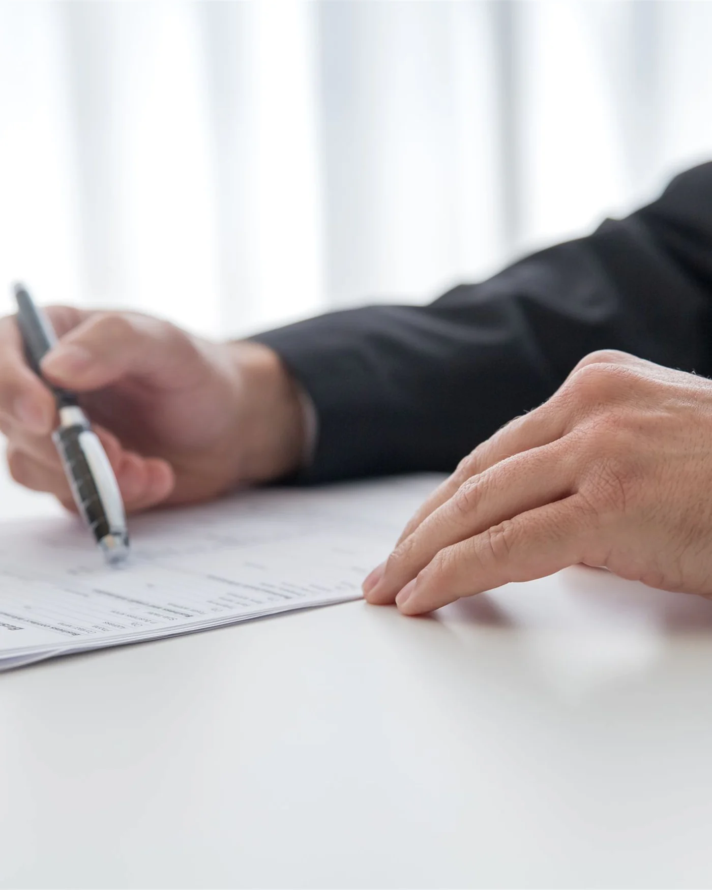 A commercial lease agreement being signed at a bright office desk