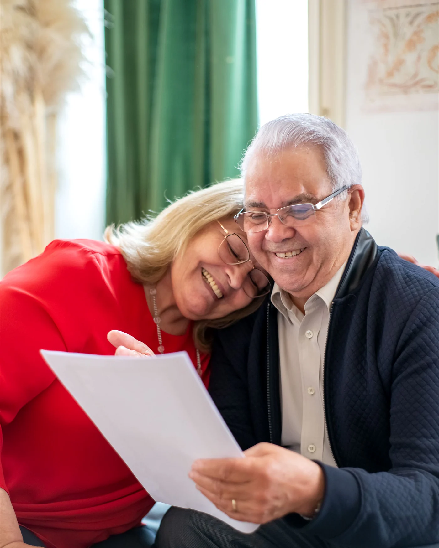 A couple reading through a document together at home