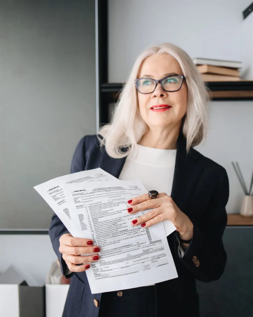 A lawyer holding estate documents in an office