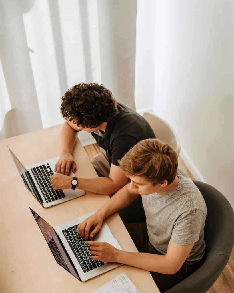Colleagues working through a problem together at their desks
