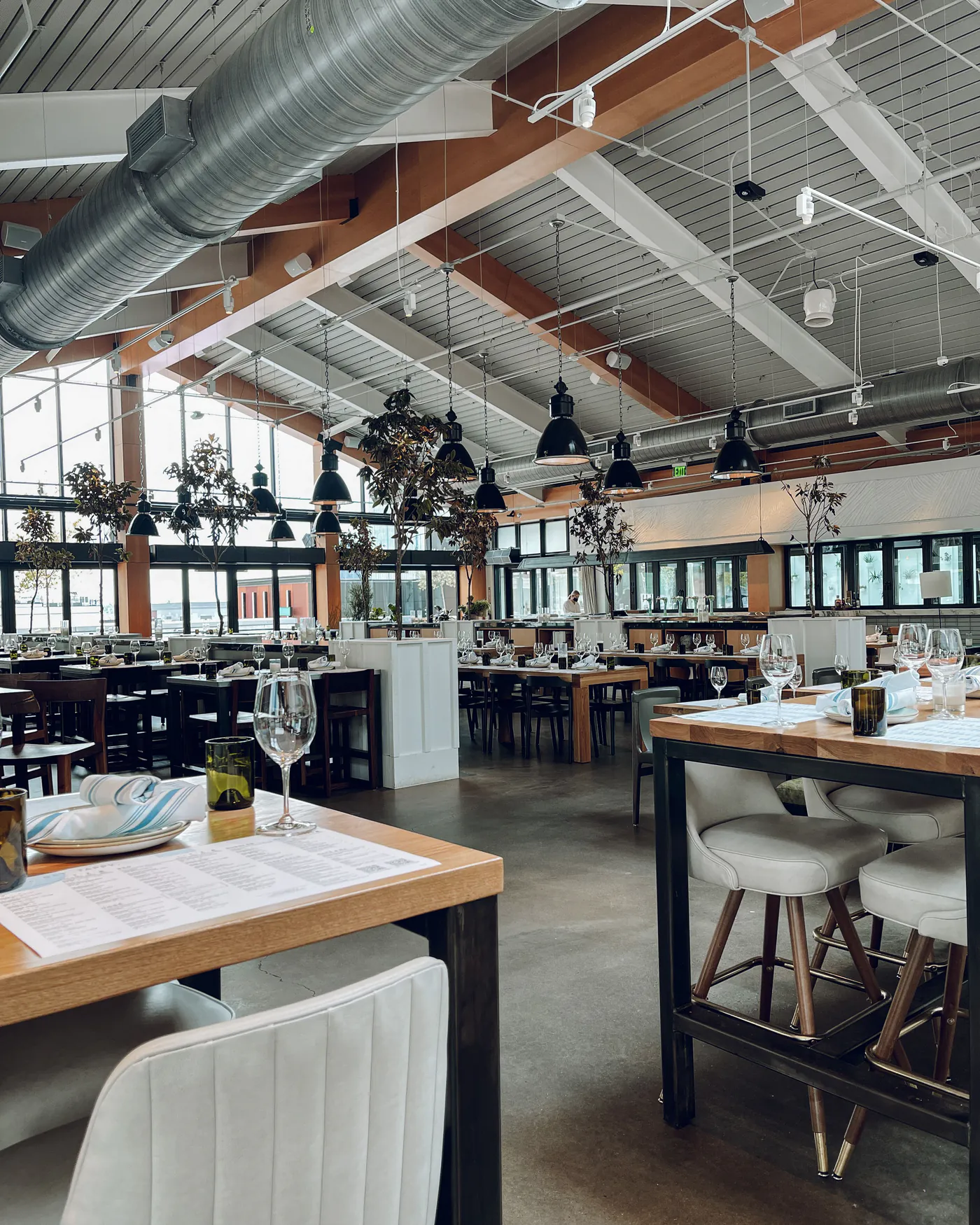 Tables and upholstered chairs in a bright restaurant dining room