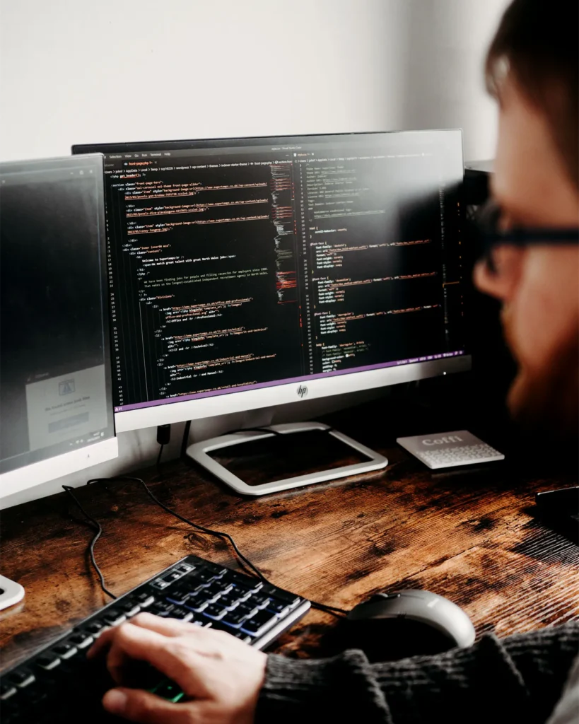 A developer working on code at a monitor