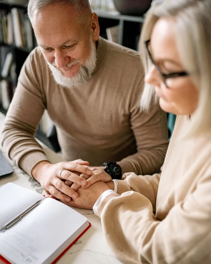 An older couple going through paperwork together at home