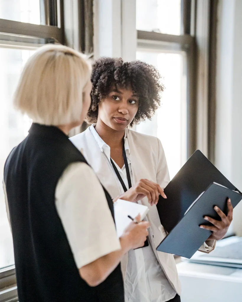 Two colleagues discussing revised lease terms in a bright office