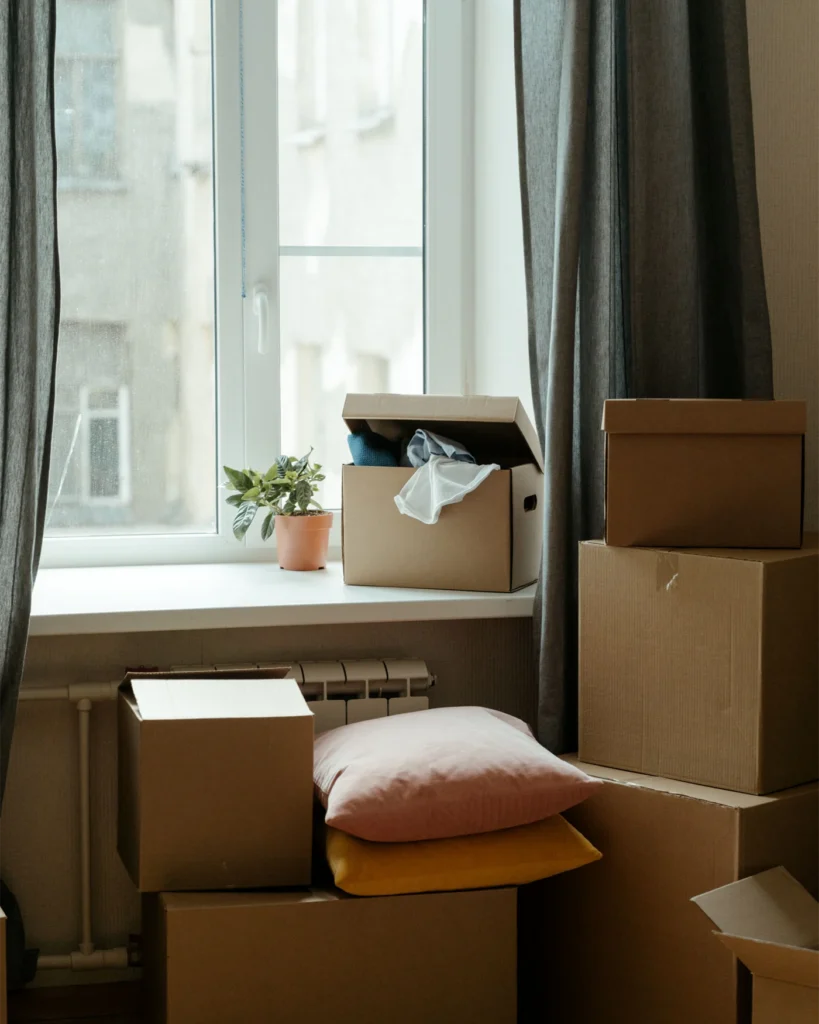 Packing boxes stacked by a window as premises are vacated