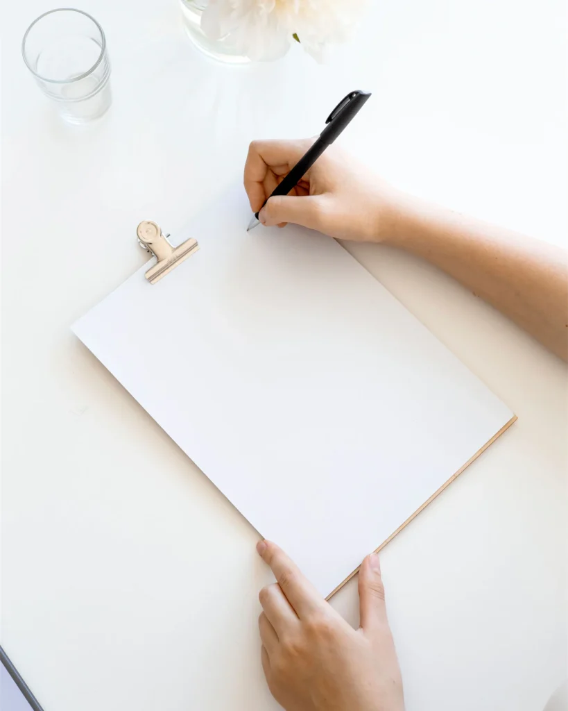 A waiver document being completed at a bright desk
