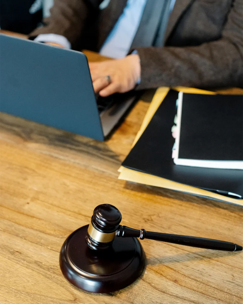 A gavel and tabbed case folders on a lawyer desk