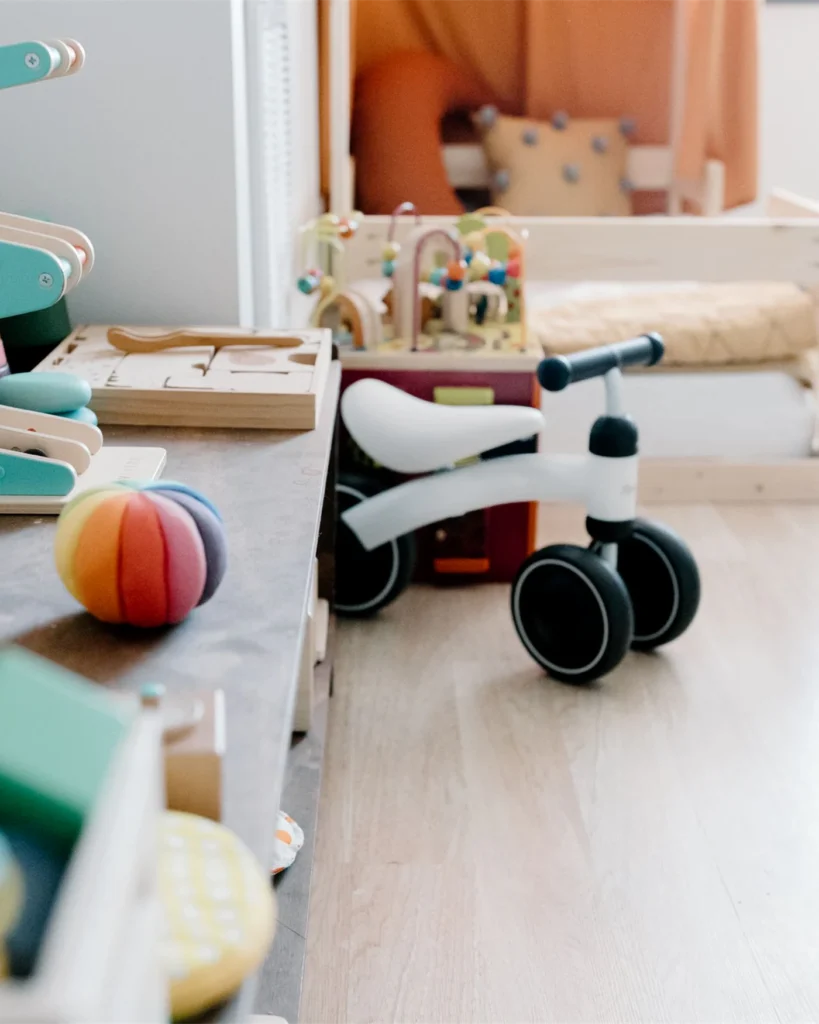 A bright playroom with wooden toys and a balance bike