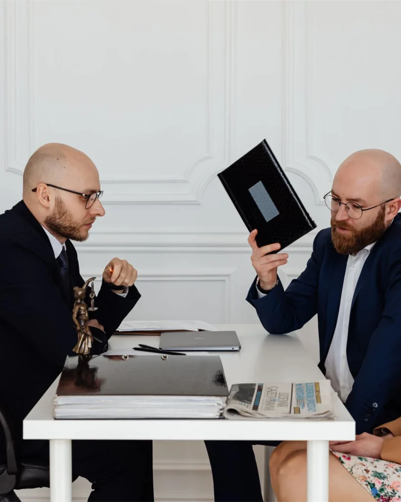 A couple discussing matters with a lawyer at a desk