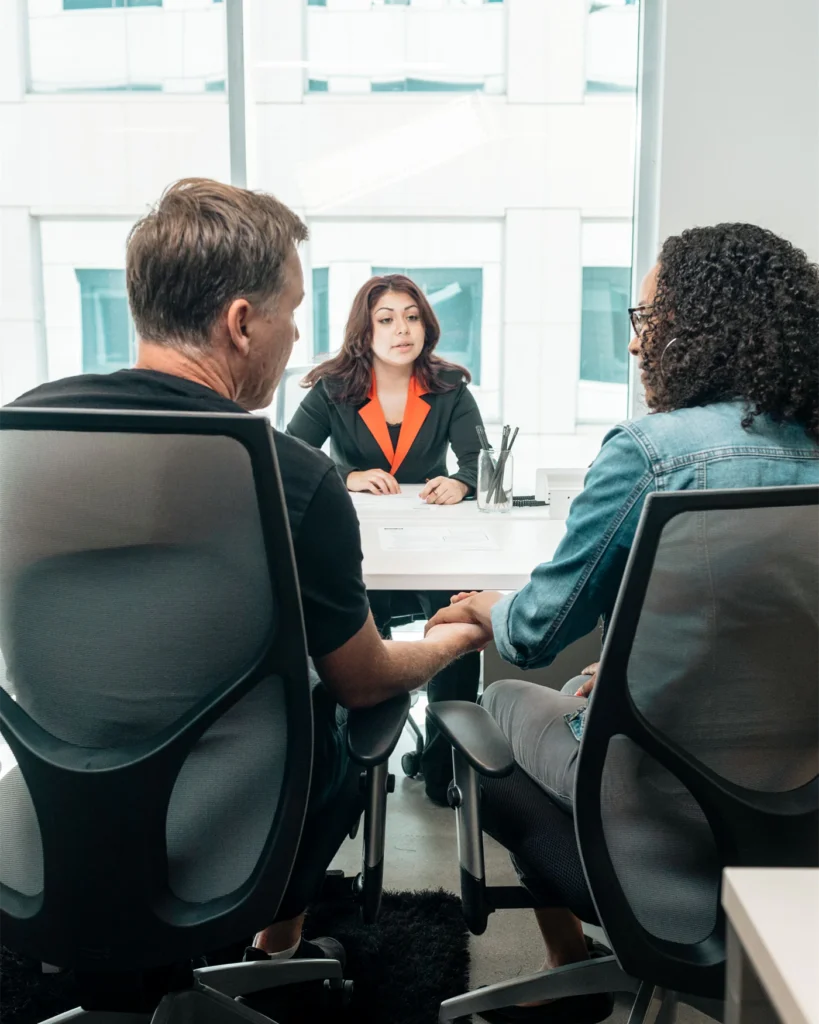 A couple holding hands during a legal consultation