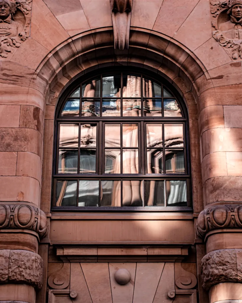 A carved stone window on a civic building in Stockholm