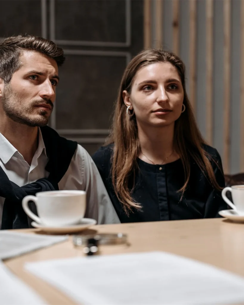 A couple in discussion with an adviser at a table